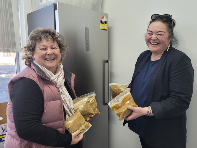Michelle DaSilva (left) and Tokomairiro Community Hub coordinator Joeline Ratana stock up the Hub's new freezer