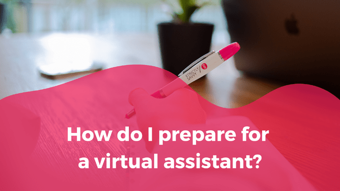 A hand holding a pink pen with the question "How do I prepare for a virtual assistant?" in bold white text, set against a blurred desk background with a plant and laptop