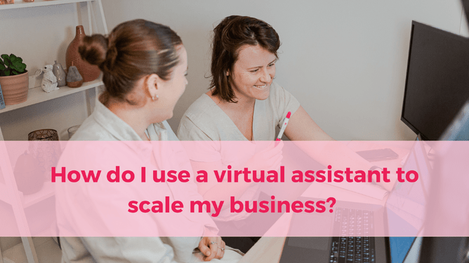 Two women sitting together at a desk, working on a computer, with a pink overlay featuring the text 'How do I use a virtual assistant to scale my business?'