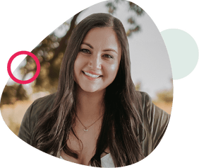 Smiling woman with long dark hair, wearing a white top and olive cardigan, framed by abstract beige and pink shapes