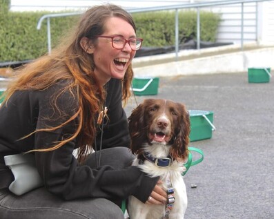 A happy lady training her happy dog