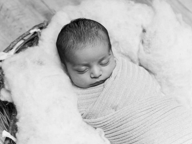 Indian Newborn baby wrapped in a nest