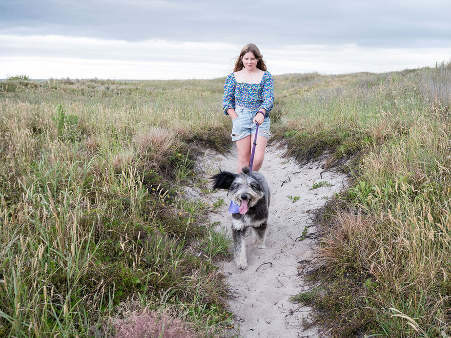 Girl with dog on beach. Tauranga Photographer.  Tauranga Family Photographer.  Papamoa Family Photographer.  Family.  Bay of Plenty Photographer.