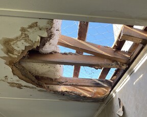Image of damaged roof with hole in it
