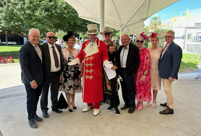 Aha Family & Friends Syndicate Members arriving at the gate for the Golden Slipper and posing with the flamboyant Raceday host.