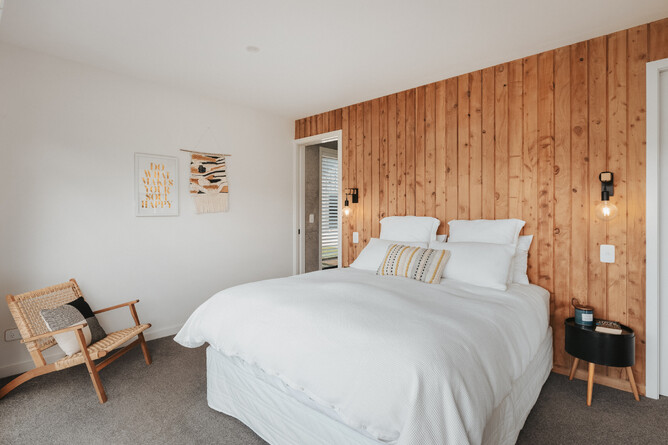 Interior master bedroom featuring recycled macrocarpa panelling - Radbull Barn