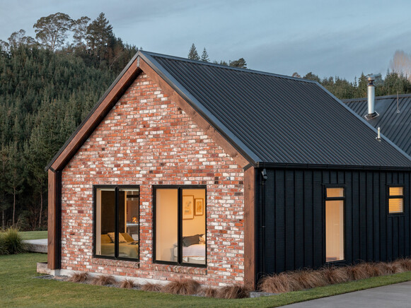 Black board and batten home with recycled bricks