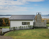 Pool house design with fair face concrete fireplace