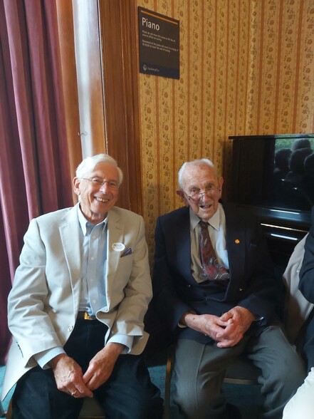 Two men smiling at the camera.