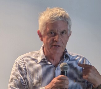 Man speaking into a microphone.