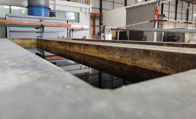 Photo of chemical pre-treatment dip tank inside Hamilton Industrial Powdercoating's workshop