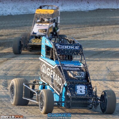 Photo of a sprint car powder coated by Hamilton Industrial Powder Coating on a race track, car sponsor reads "HAMILTON INDUSTRIAL POWDERCOATING" on front of car