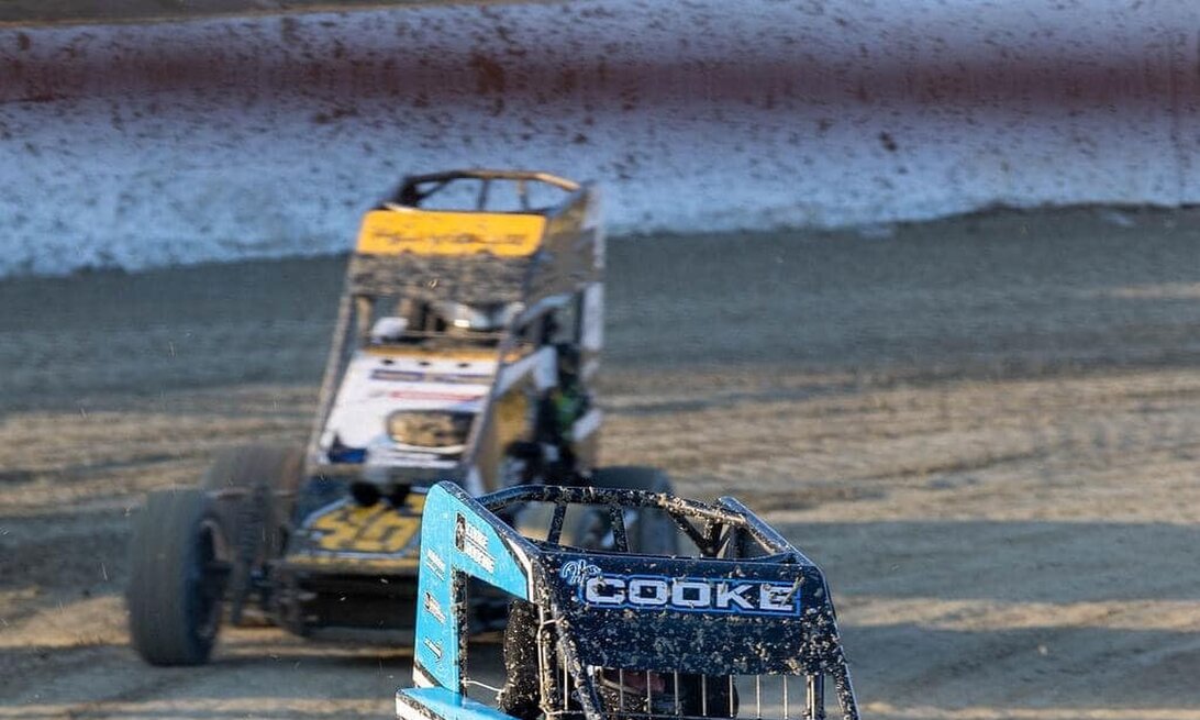 Photo of a sprint car powder coated by Hamilton Industrial Powder Coating on a race track, car sponsor reads "HAMILTON INDUSTRIAL POWDERCOATING" on front of car