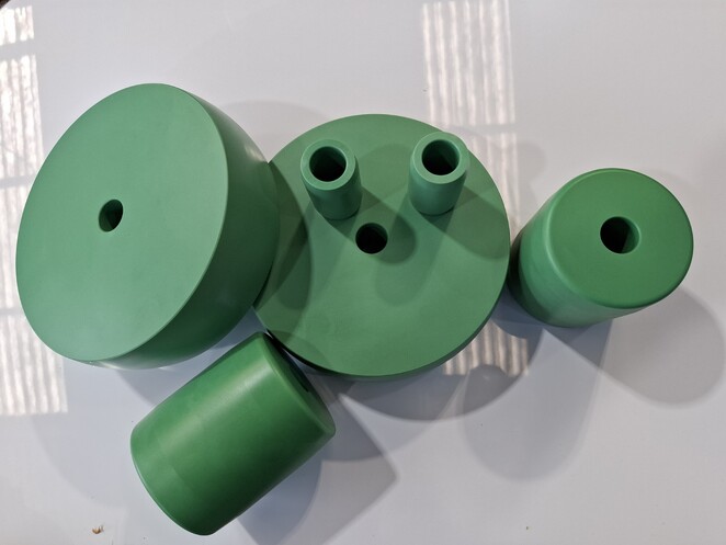 Close-up of CNC-milled aluminium block featuring recessed geometric cavities and sharp internal corners.