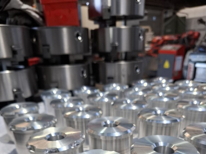 Close-up of CNC-milled aluminium block featuring recessed geometric cavities and sharp internal corners.