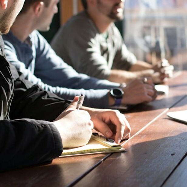 Three staff members at table together.