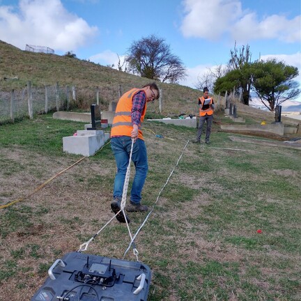 two scientist using ground surveying equipment