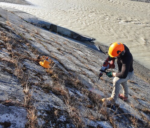 A metal ruler measuring a hole depth