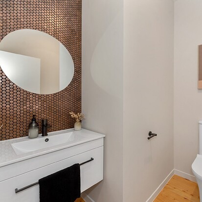 Image of mosaic tiled wall in bathroom. Tiling service by Cosmic Tiling for Waikato Build. Waikato.