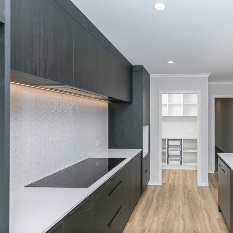 Image of modern tiled kitchen back splash. Tiling service by Cosmic Tiling. Waikato.