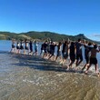 Young people lined up in the water