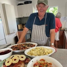 Comfort Kai image of man with plates of food on a table