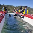 Kids in a double hulled kayak