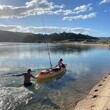 Kids playing - one in the water and one in a kayak