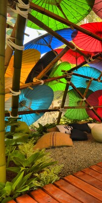 Ben Lowry Hoyle designed exhibition garden of remembrance with a vibrant canopy of parasol umbrellas providing sanctuary within this garden oasis