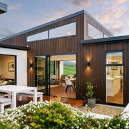 Outdoor dining area with pergola &mdash; relaxed weekend living, Raglan home