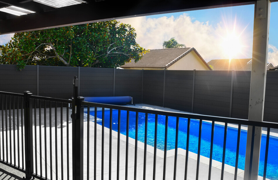 Black aluminimum pool fencing with charcoal composite boundary fence