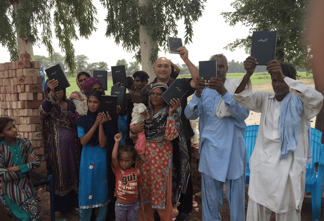 Pastor Lui Ponifasio and Pakistani believers with their new Bibles during Lui's last visit