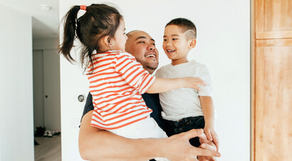 Father having fun teaching his son to ride a bike