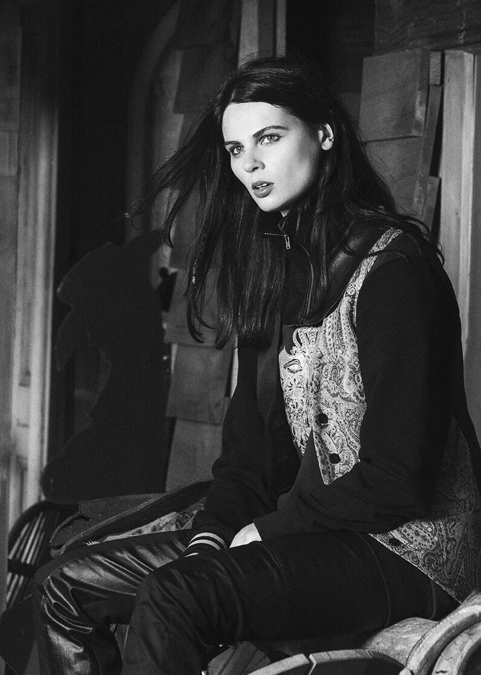 A model sitting while wearing a garment designed and created by Jane Sutherland. Photographed at Gibbston, Queenstown.