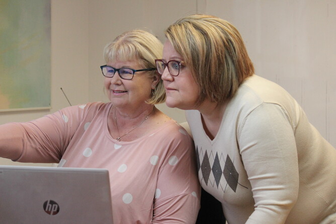 Two women looking at a computer screen