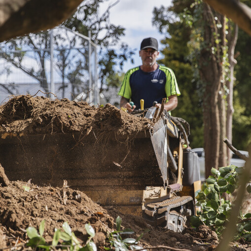 Ultrascape team removing site debris after clearing land for site prep