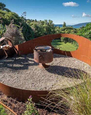 Custom landscape design with native planting and stone features and rolled lawn