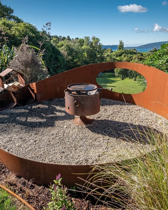 Custom landscape design with native planting and stone features and rolled lawn