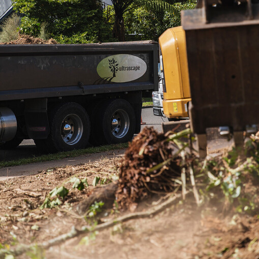 Ultrascape team using a digger to clear land for site preparation