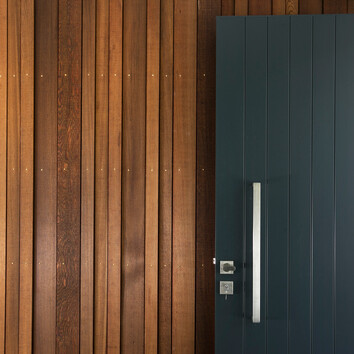 Internal timber cladding and black front door 