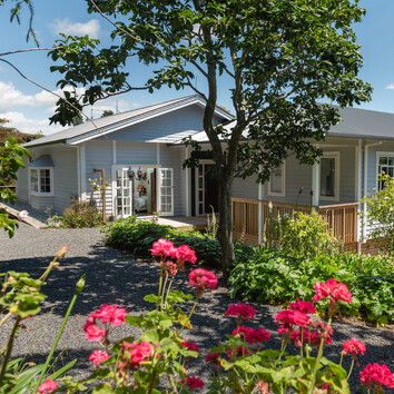 traditional light blue weatherboard home.