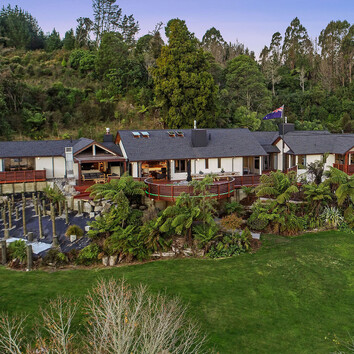 Arial view of large family home surrounded by New Zealand native bush.