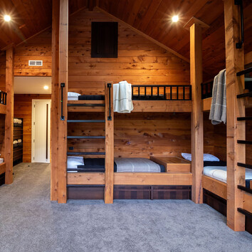 built-in timber beds in a rustic timber bedroom.