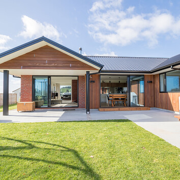 Red Brick home with concrete patio.