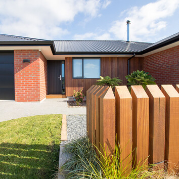 Red Brick home with timber fence 