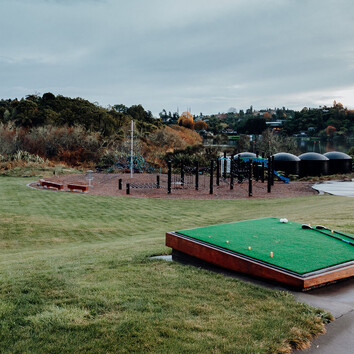 outdoor driving range with kids play park in the distance. 