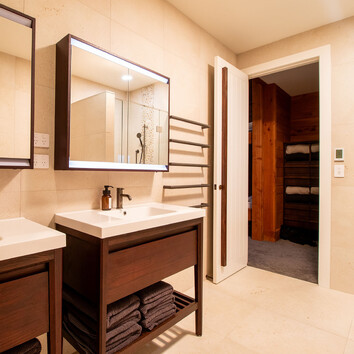 modern bathroom with twin freestanding vanities.