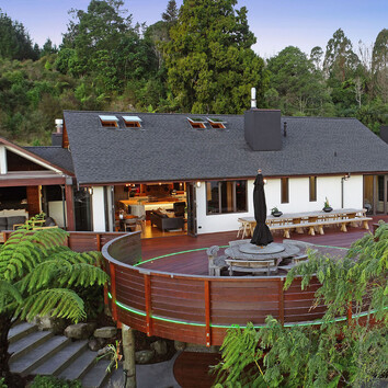 Large family home with deck nestled in New Zealand native bush.