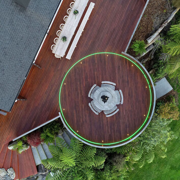 arial view of the deck with circular deck seated area and green floor lights.