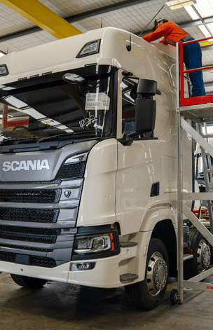 Man inspecting a heavy truck for truck preparation services